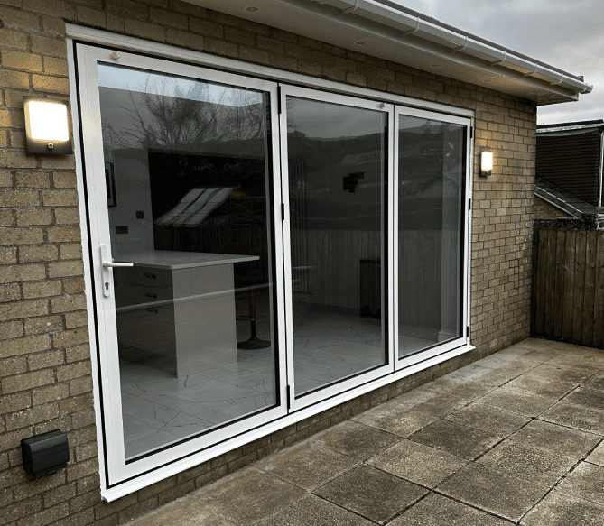 A large sliding glass door in the middle of a patio.