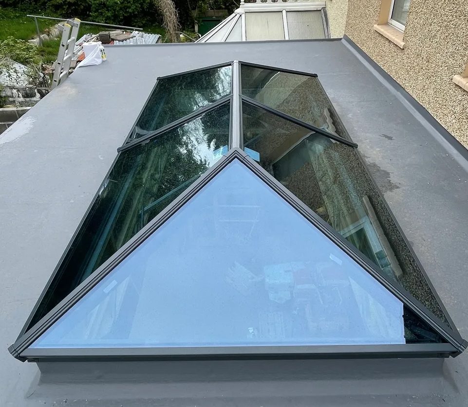 A skylight that is in the middle of a roof.